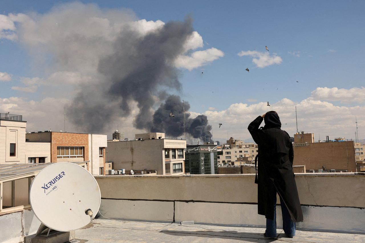 Smoke rises following an explosion, after Israel and the US launched strikes on Iran, in Tehran, Sunday. (Reuters-Yonhap)