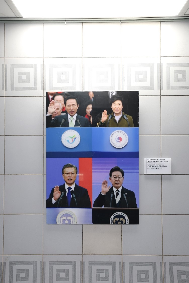 This photo shows a collage of former presidents and incumbent President Lee Jae Myung (right, bottom) placed along an aisle of a basement floor of the National Assembly's main building on Tuesday. (Courtesy of Rep. Woo Won-shik's office)