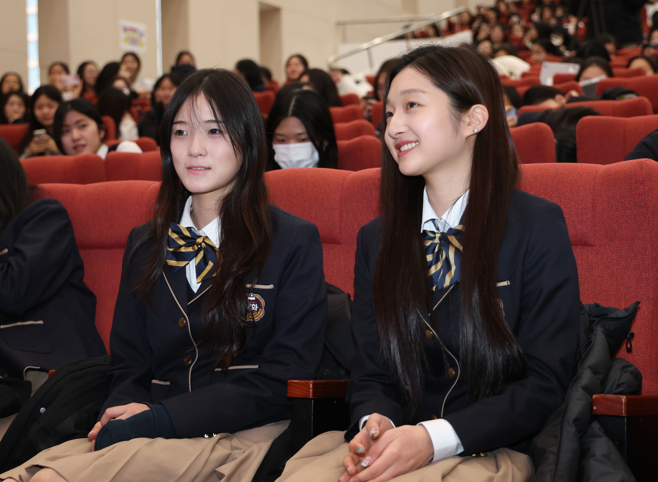 Snowboarder Choi Ga-on (left) and figure skater Shin Ji-a, who competed in the 2026 Milan Cortina Winter Olympics, attend the opening ceremony at Sewha Girls' High School in Seoul on Tuesday. (Yonhap)