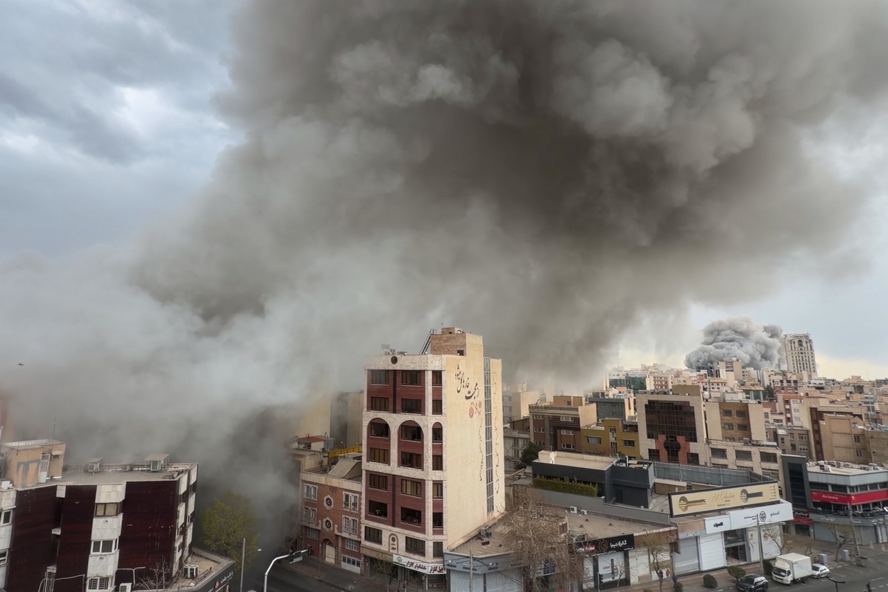 Plumes of smoke from two simultaneous strikes rise over Tehran, Iran, Monday. (AP-Yonhap)