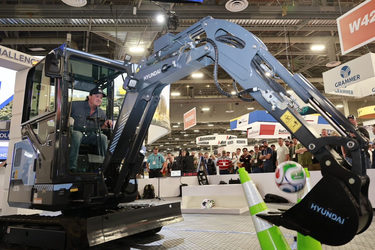A participant tries the “Operator Challenge” at HD Construction Equipment’s exhibition booth during Conexpo-Con/Agg 2026 in Las Vegas. (HD Construction Equipment)