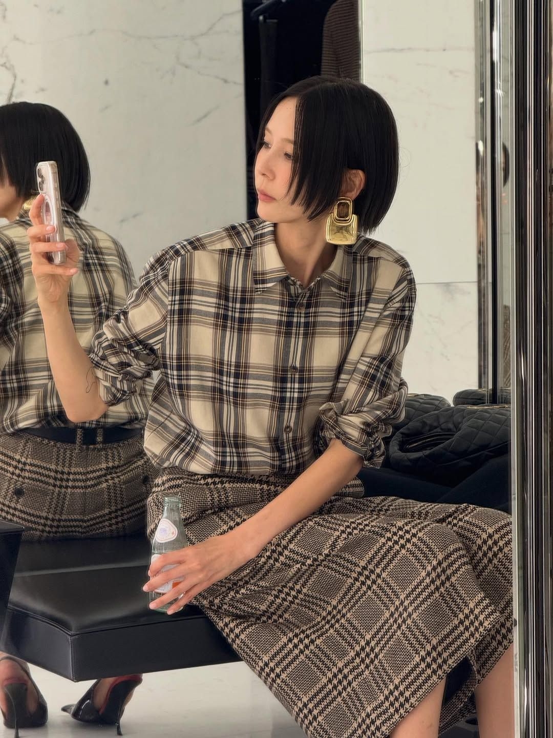 Kim Na-young wearing a check shirt and bold gold earrings (Instagram)