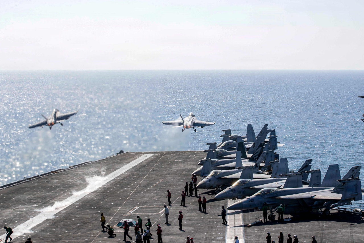 Two F/A-18 Super Hornets launch from the flight deck of Nimitz-class aircraft carrier USS Abraham Lincoln in support of Operation Epic Fury on Tuesday. (AFP-Yonhap)