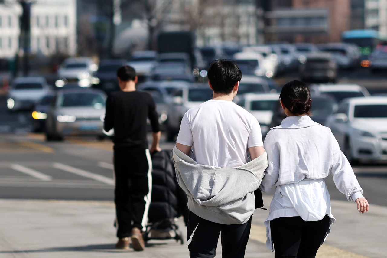 Pedestrians walk near Gwanghwamun Square in central Seoul on Feb. 21. (Yonhap)