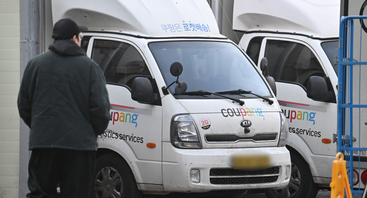 Delivery trucks are parked at a Coupang logistics center in Seoul on Friday. (Im Se-jun/The Korea Herald)