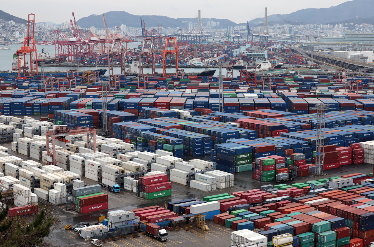 Containers are stacked at a port in Busan on Friday. (Yonhap)