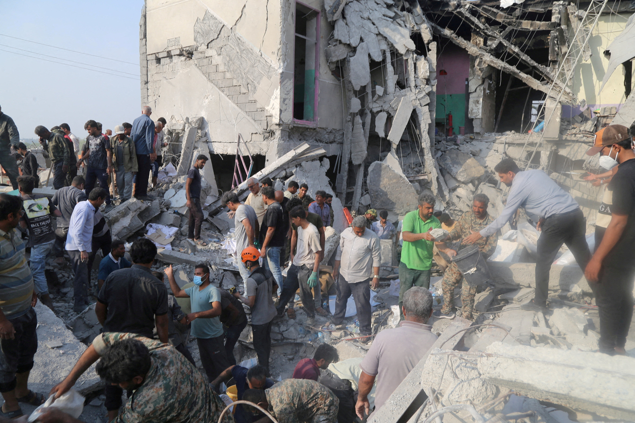 People and rescue forces work following a reported strike on a school in Minab, Iran, Feb. 28.   Reuters-Yonhap