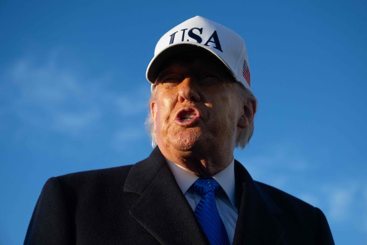 US President Donald Trump speaks to reporters before boarding Air Force One as he departs Joint Base Andrews in Maryland on Friday. (AFP-Yonhap)