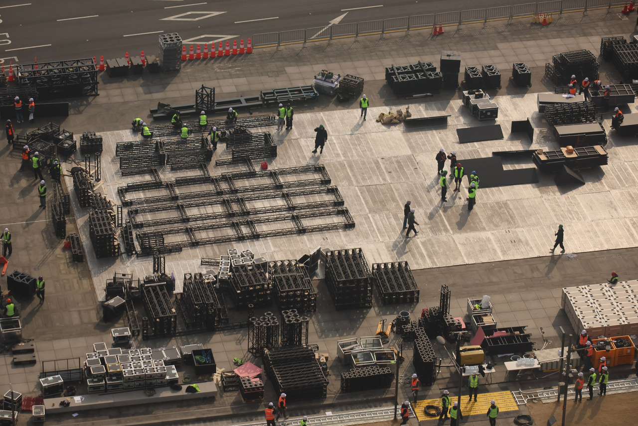 Workers set up a stage for BTS’ comeback concert at Gwanghwamun Square in Seoul on Monday. (Yonhap)