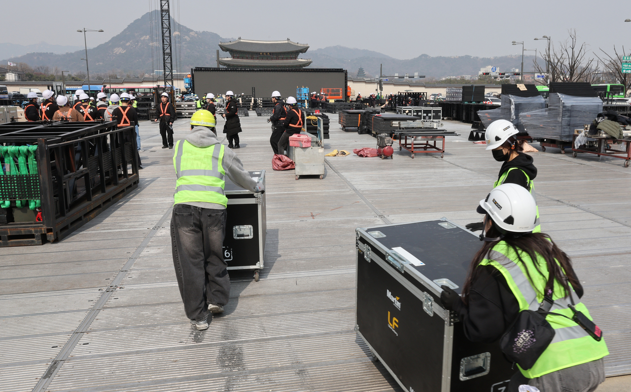 Workers set up a stage for BTS’ comeback concert at Gwanghwamun Square in Seoul on Monday. (Yonhap)
