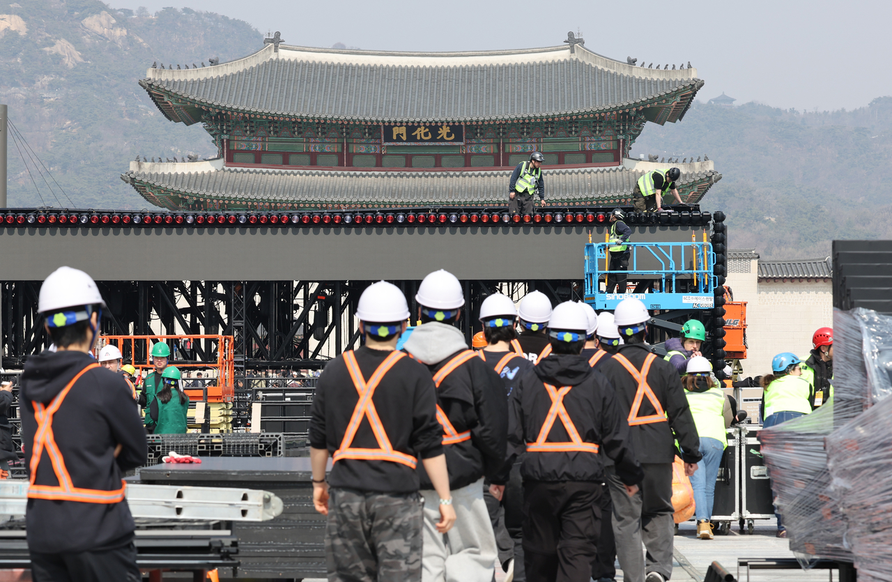 Workers set up a stage for BTS’ comeback concert at Gwanghwamun Square in Seoul on Monday. (Yonhap)