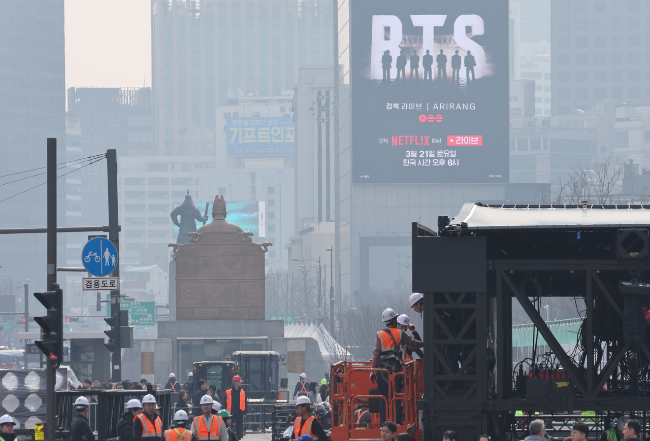 Workers set up a stage for BTS’ comeback concert at Gwanghwamun Square in Seoul on Monday. (Yonhap)
