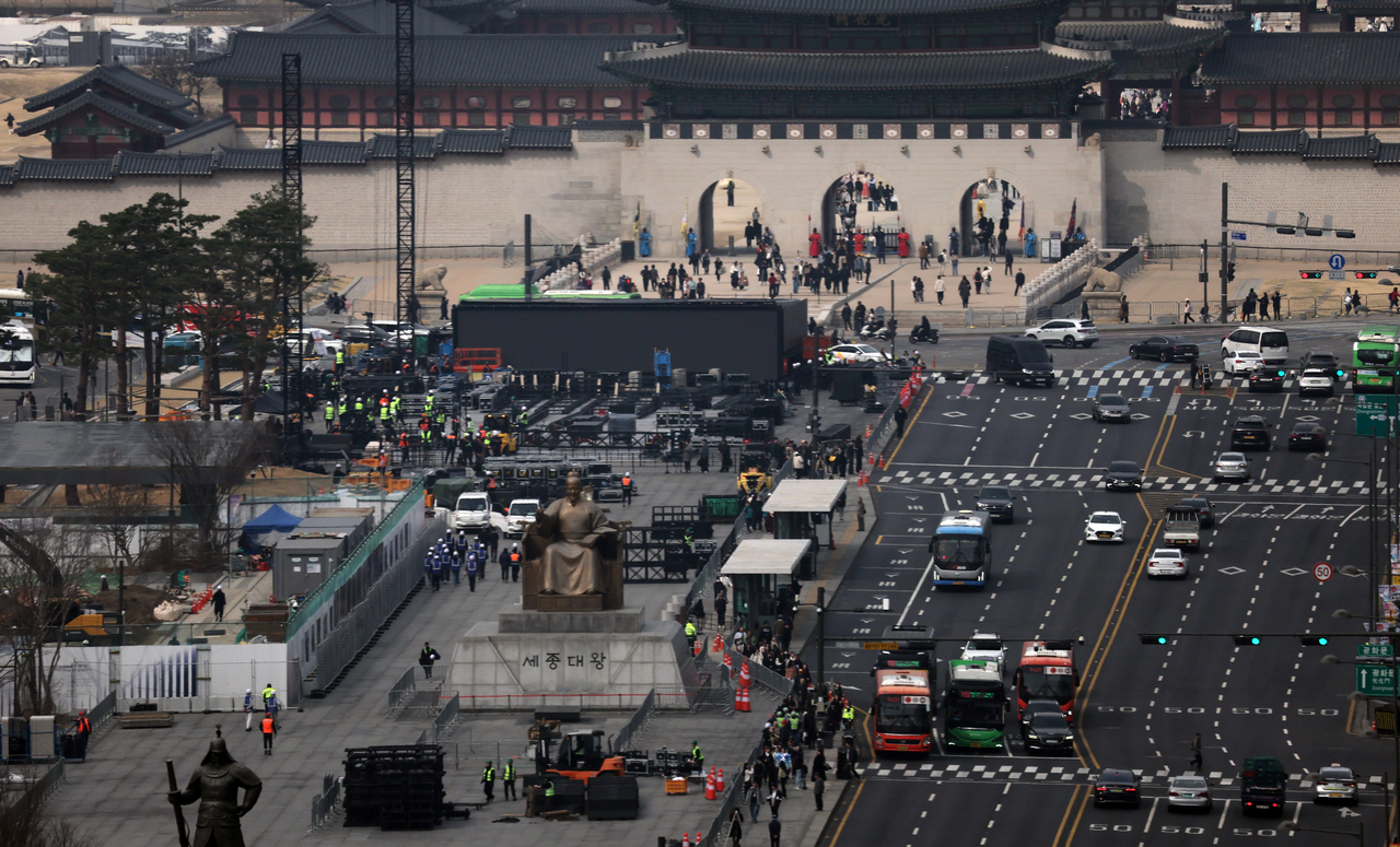 Workers set up a stage for BTS’ comeback concert at Gwanghwamun Square in Seoul on Monday. (Yonhap)