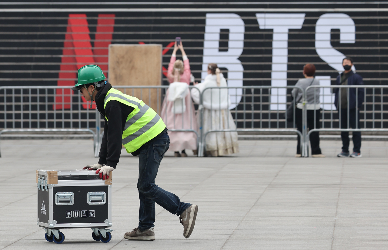 Workers set up a stage for BTS’ comeback concert at Gwanghwamun Square in Seoul on Monday. (Yonhap)