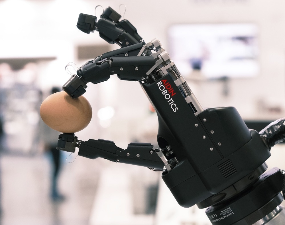 A robot hand developed by Korean sensor firm Aidin Robotics grips an egg using miniature six-axis force sensors embedded in each fingertip. (Aidin Robotics)