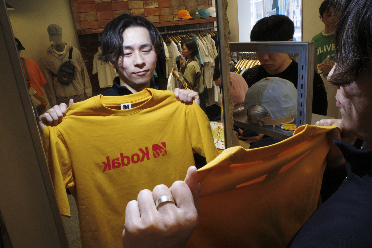 A Japanese tourist examines a Kodak T-shirt while shopping at the Kodak Corner store in the Seongsu-dong neighborhood of Seoul on May 4, 2025. (Getty Images)