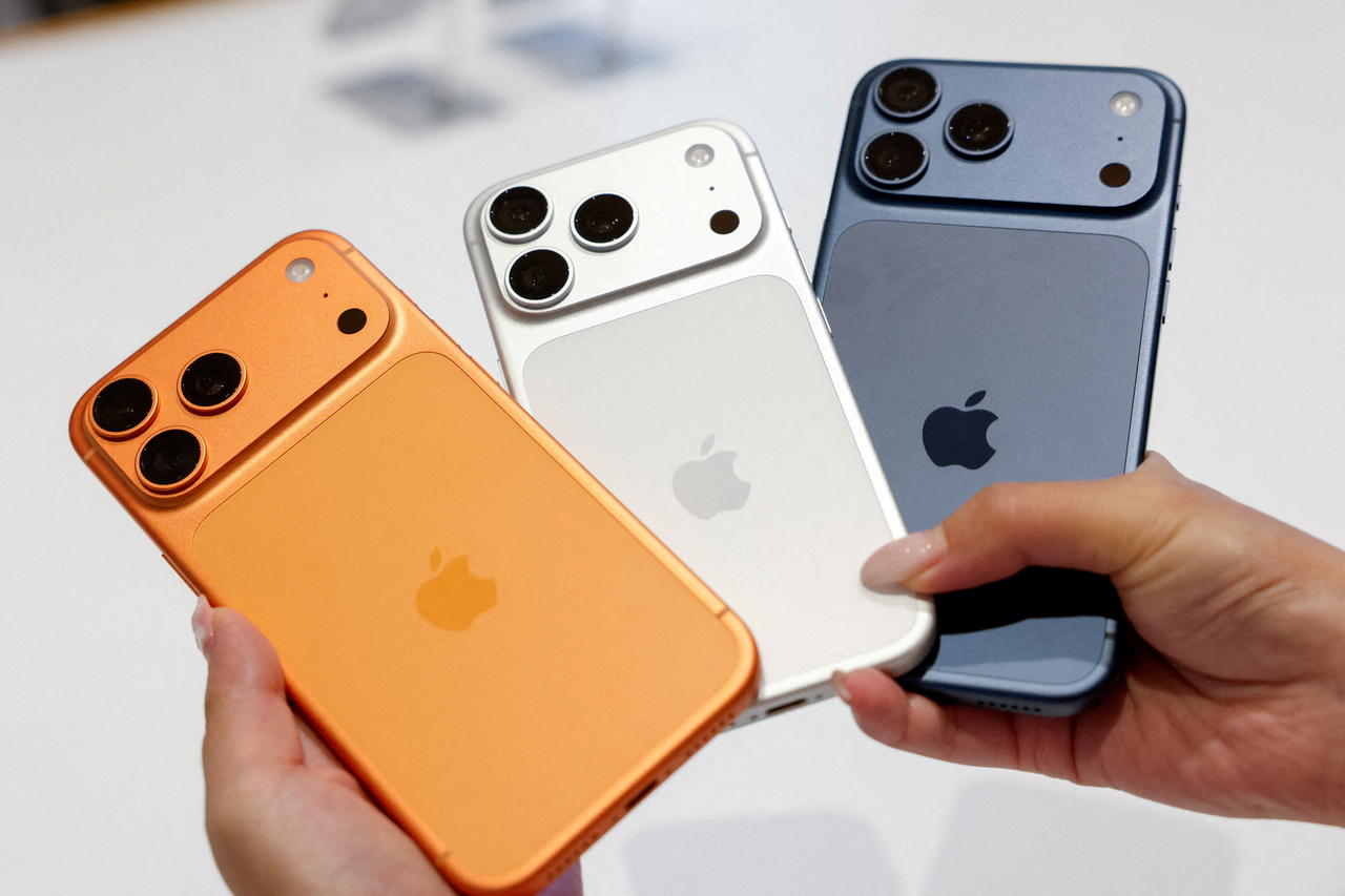 A person holds Apple's new iPhone 17 series at an Apple store in Taipei, Taiwan, in September 2025. (Reuters-Yonhap)