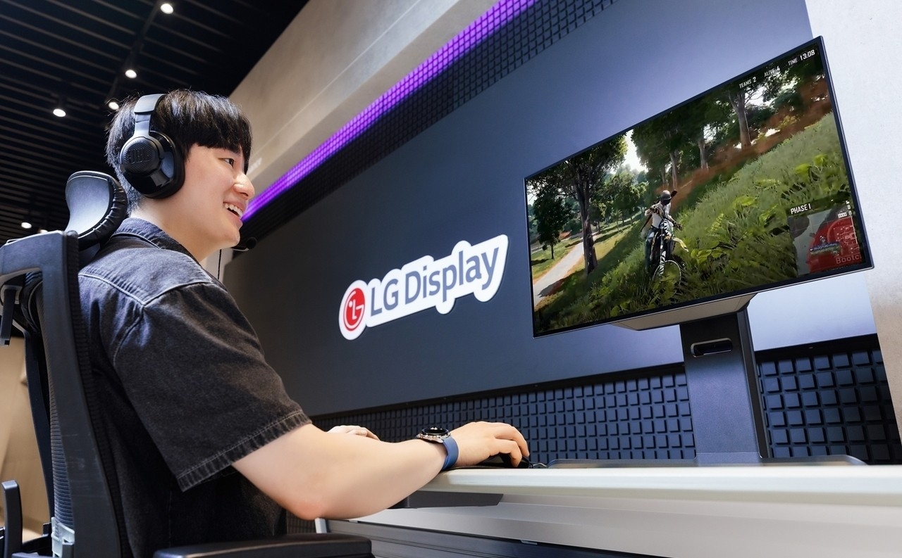 A user plays a game on a 27-inch OLED monitor panel featuring LG Display’s fourth-generation primary RGB tandem technology, designed to deliver higher brightness and ultrafast response times. (LG Display)