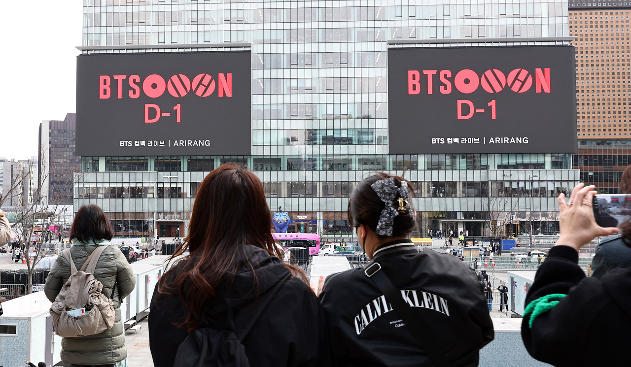 A screen at Gwanghwamun Square in Jongno-gu, Seoul, plays a video related to BTS’ comeback performance on Friday, a day before the show. (Yonhap)