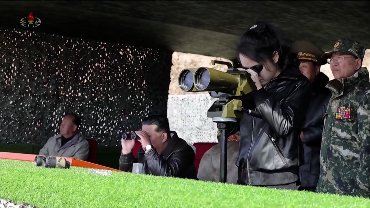 North Korean leader Kim Jong-un (center) and his daughter Ju-ae (right) oversee a coordinated offensive tactical drill of infantrymen's and tankmen's subunits on Thursday, at the Pyongyang Training Base No. 60 under the Capital City Defence Corps of the Korean People's Army, in this footage released by the Korean Central Television the following day. (KCTV-Yonhap)