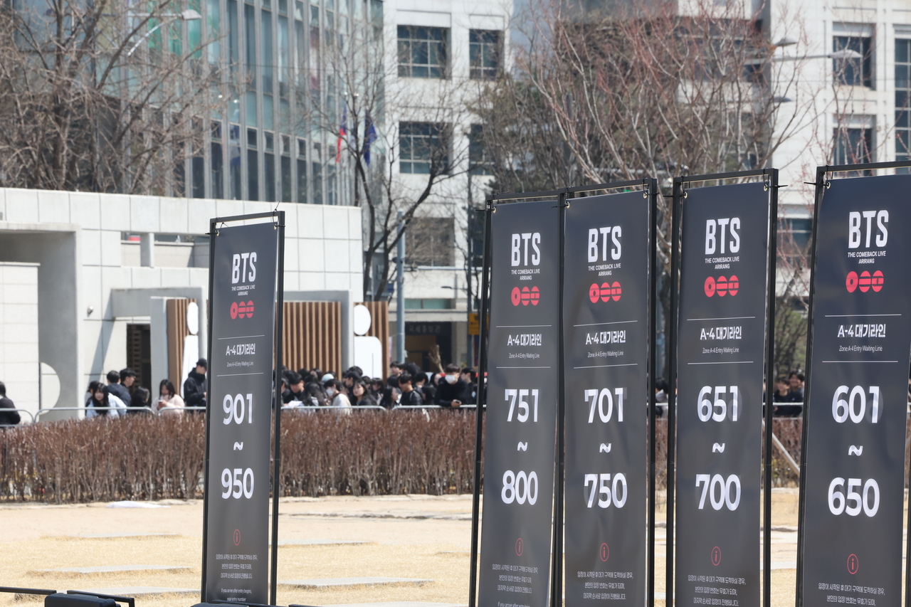 Notice boards for queues to enter the BTS comeback concert venue at Gwanghwamun Square are seen set up near the site on Friday. (Yonhap)