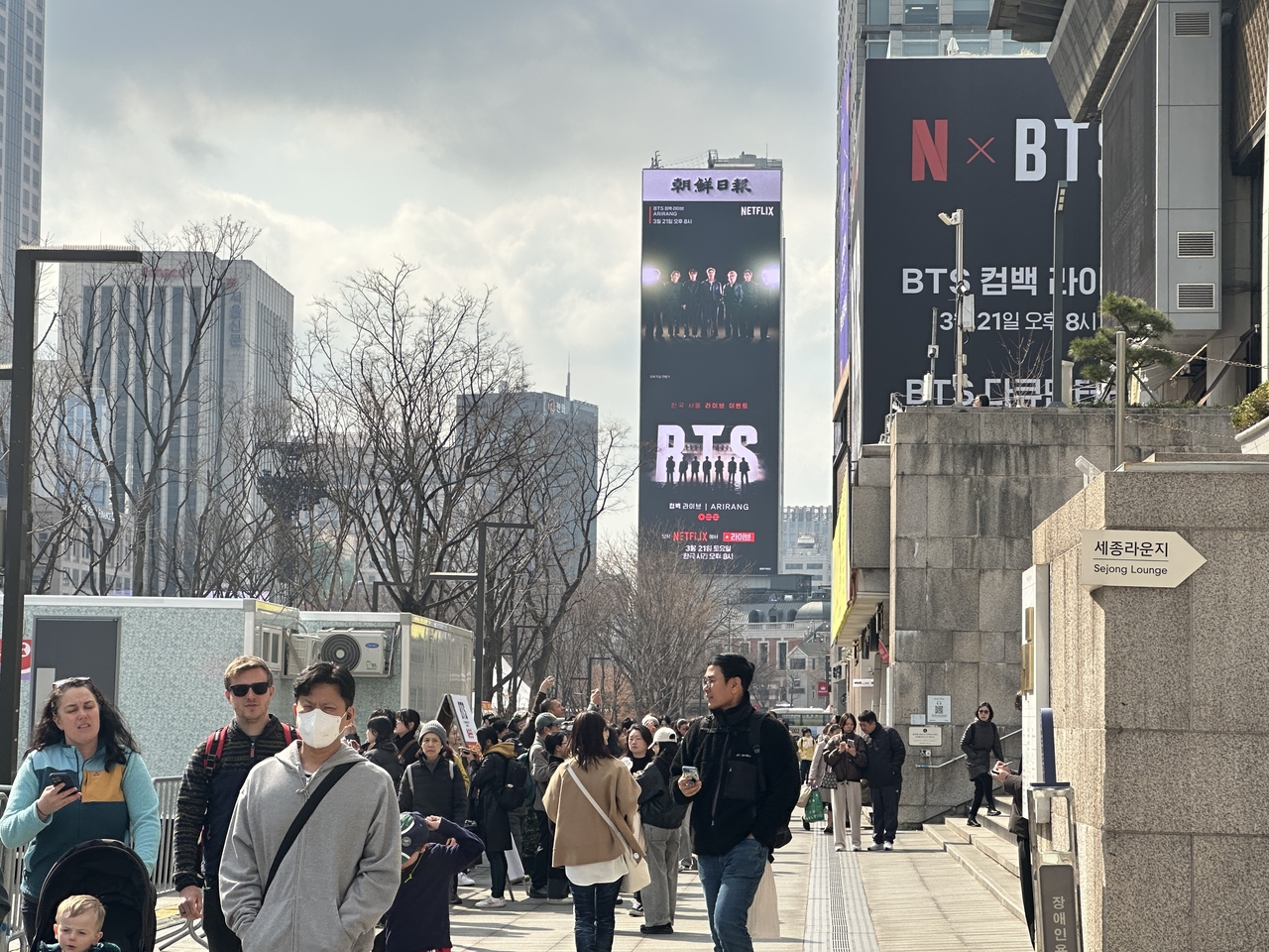 Netflix's advertisement for BTS' comeback show plays on a megascreen on Koreana Hotel in central Seoul on Friday. (Lee Jung-joo/The Korea Herald)