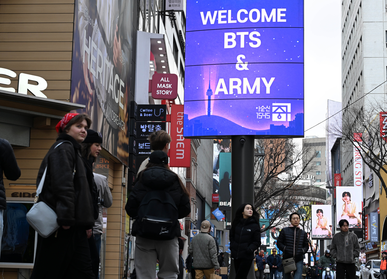 A billboard seen in Myeong-dong, Seoul, on Friday welcomes the return of BTS and its fan club Army ahead of the group's comeback concert scheduled for Saturday. (Lee Sang-sub/The Korea Herald)