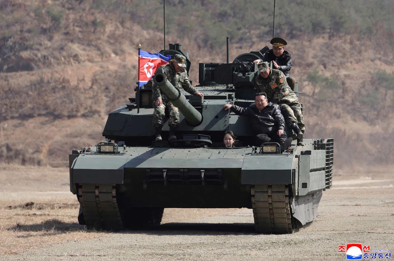 North Korean leader Kim Jong-un’s daughter, Ju-ae, is shown driving a new tank herself during an infantry-tank combined arms tactical exercise held on Thursday at Pyongyang’s 60th Training Base, as broadcast by Korean Central Television on Friday. 'Footage from KCTV via Yonhap)