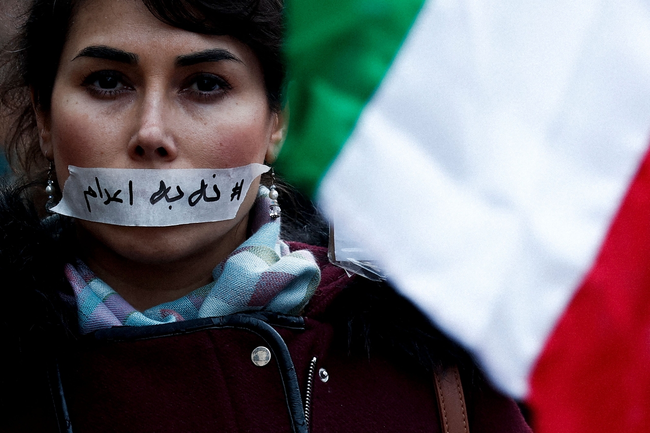 A demonstrator wears a sticker over her mouth with the words "no execution" during a silent march denouncing the Iranian government's deadly crackdown on anti-government protesters in the Islamic Republic, in Paris on January 31, 2026. (AFP/ Sébastien DUPUY)