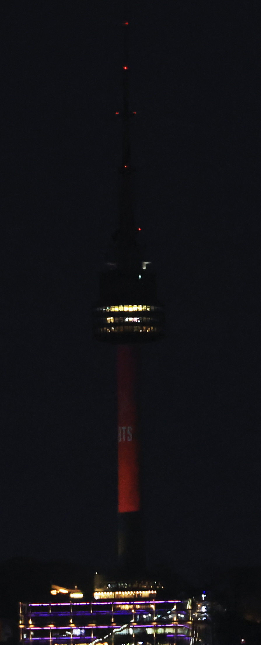 The N Seoul Tower on Mount Nam glows red, the color theme of boy group BTS' new album 