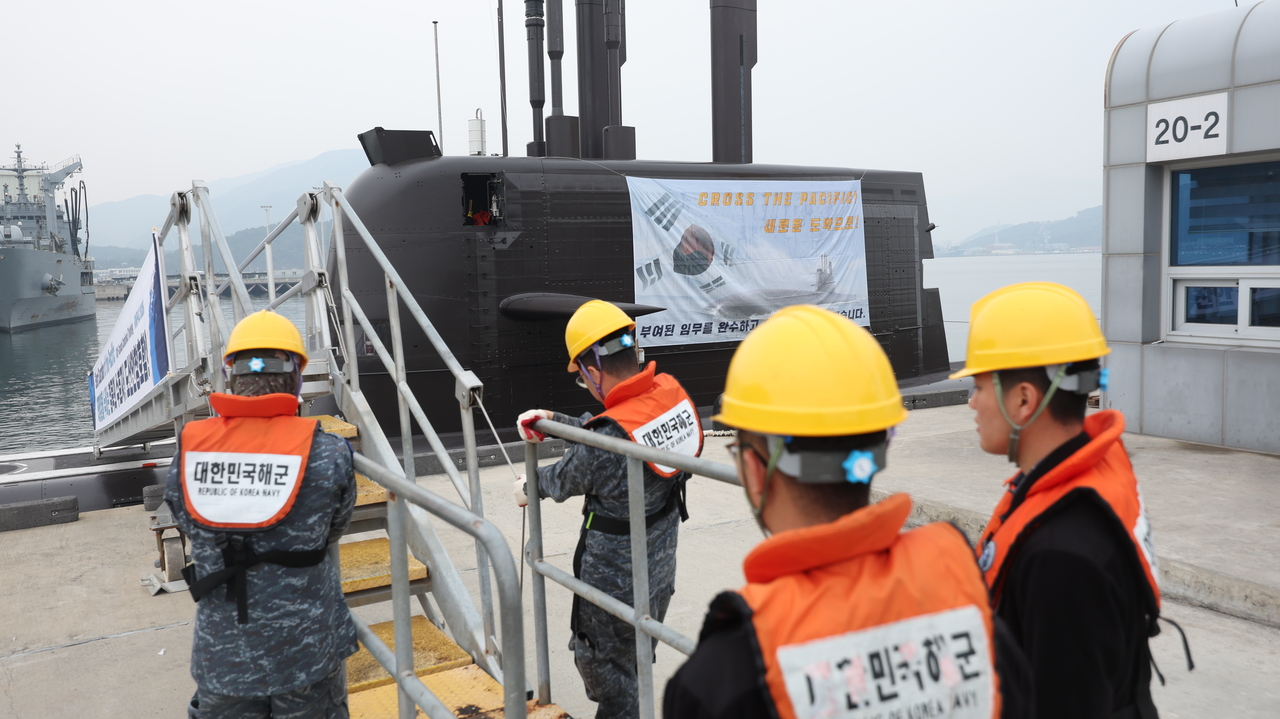 Navy officials prepare for a send-off ceremony on Wednesday for the 3,000-ton ROKS Dosan Ahn Chang-ho submarine, which will travel from Jinhae to Victoria, western Canada, to take part in joint drills scheduled for June. ()