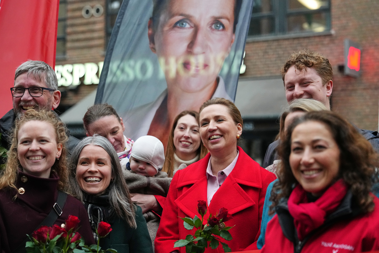 Danish Prime Minister and Leader of the Social Democrats Mette Frederiksen (center) stands with party members at a rally in her support in Copenhagen, Denmark, Tuesday. (AP-Yonhap)
