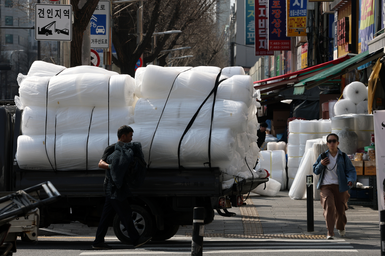 White plastic rolls are loaded on a truck in Seoul on Thursday. (Yonhap)