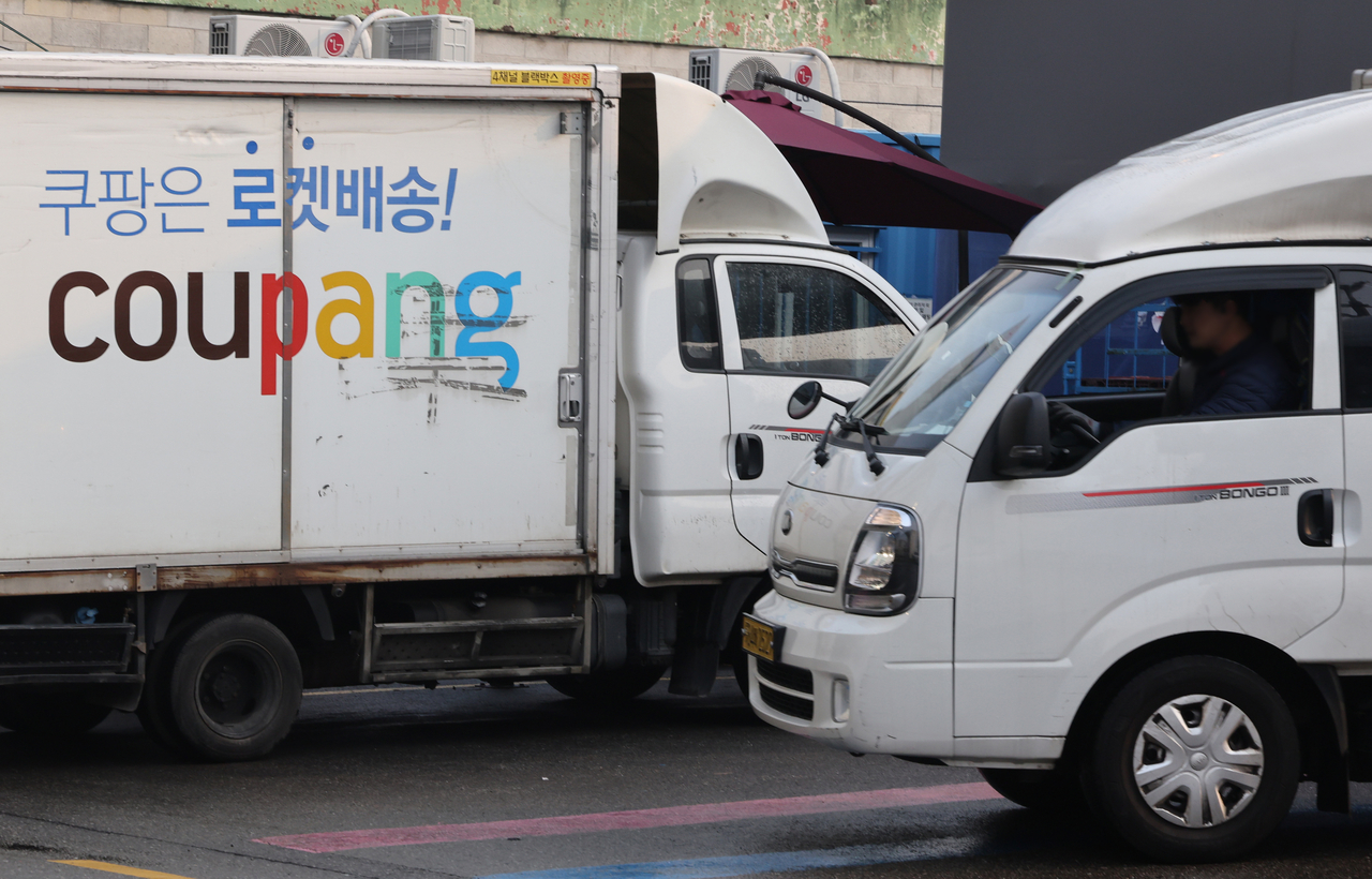 Coupang delivery vehicles are parked at a company logistics center in Seoul. (Yonhap)