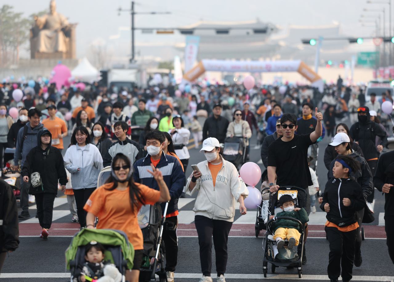 Participants set off from Gwanghwamun Square at the start of the 2026 Seoul Stroller Run on Saturday. (Yonhap)