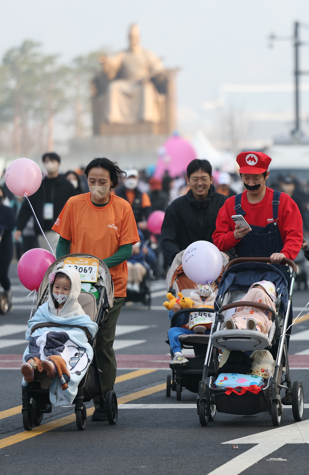 Parents push strollers carrying their children during the 2026 Seoul Stroller Run at Gwanghwamun Square in central Seoul on Saturday. (Yonhap)