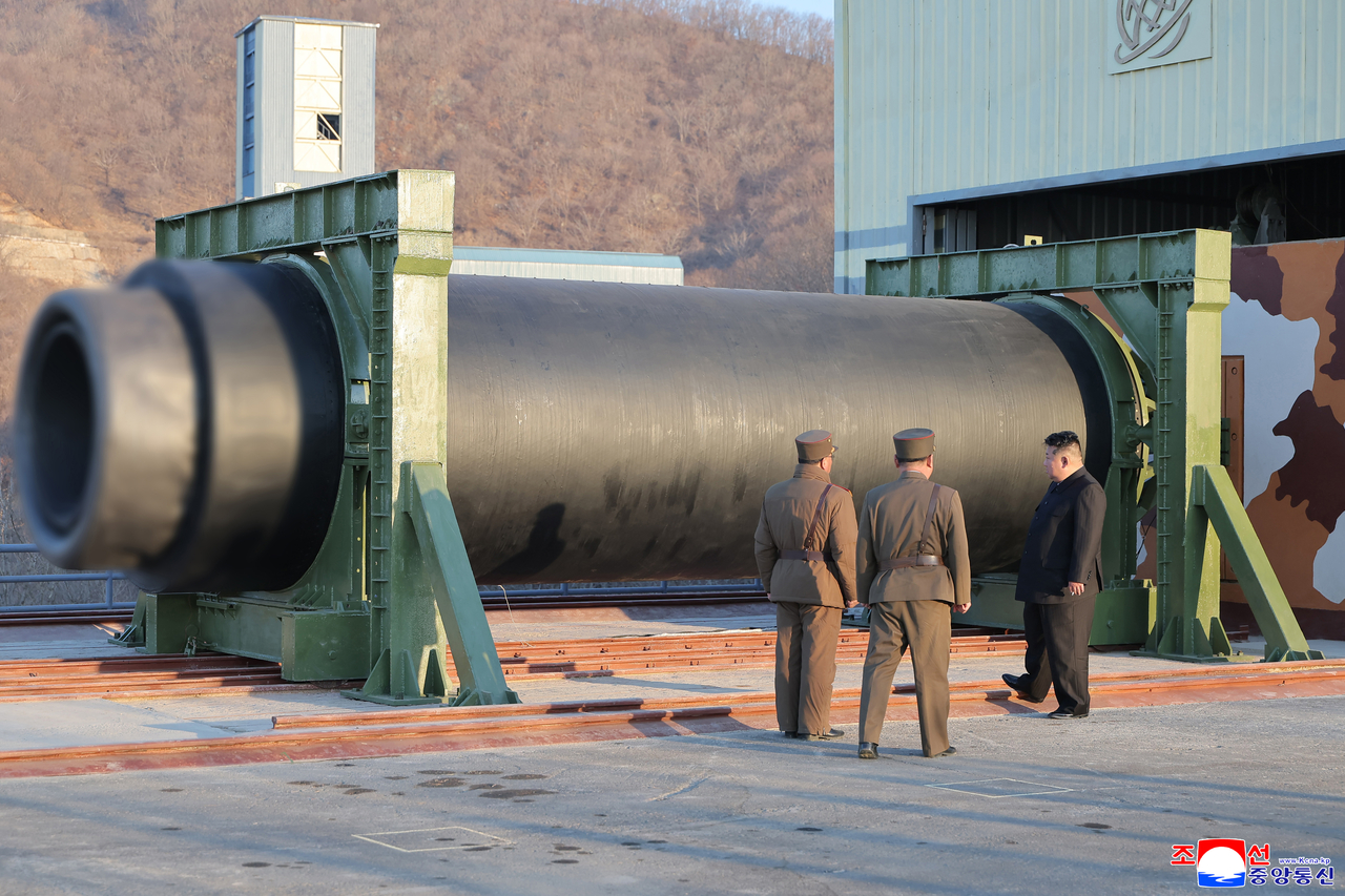 This photo, released on Sudnay, shows North Korean leader Kim Jong-un overseeing a ground test of a high-thrust solid-fuel missile engine using a composite carbon fiber material. (KCNA via Yonhap)
