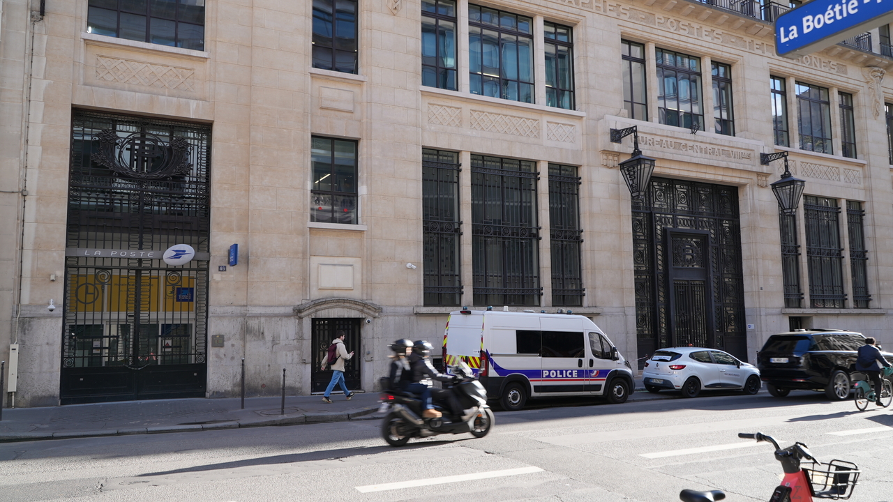 Police stand outside the Bank of America building in Paris, Saturday. (AP-Yonhap)