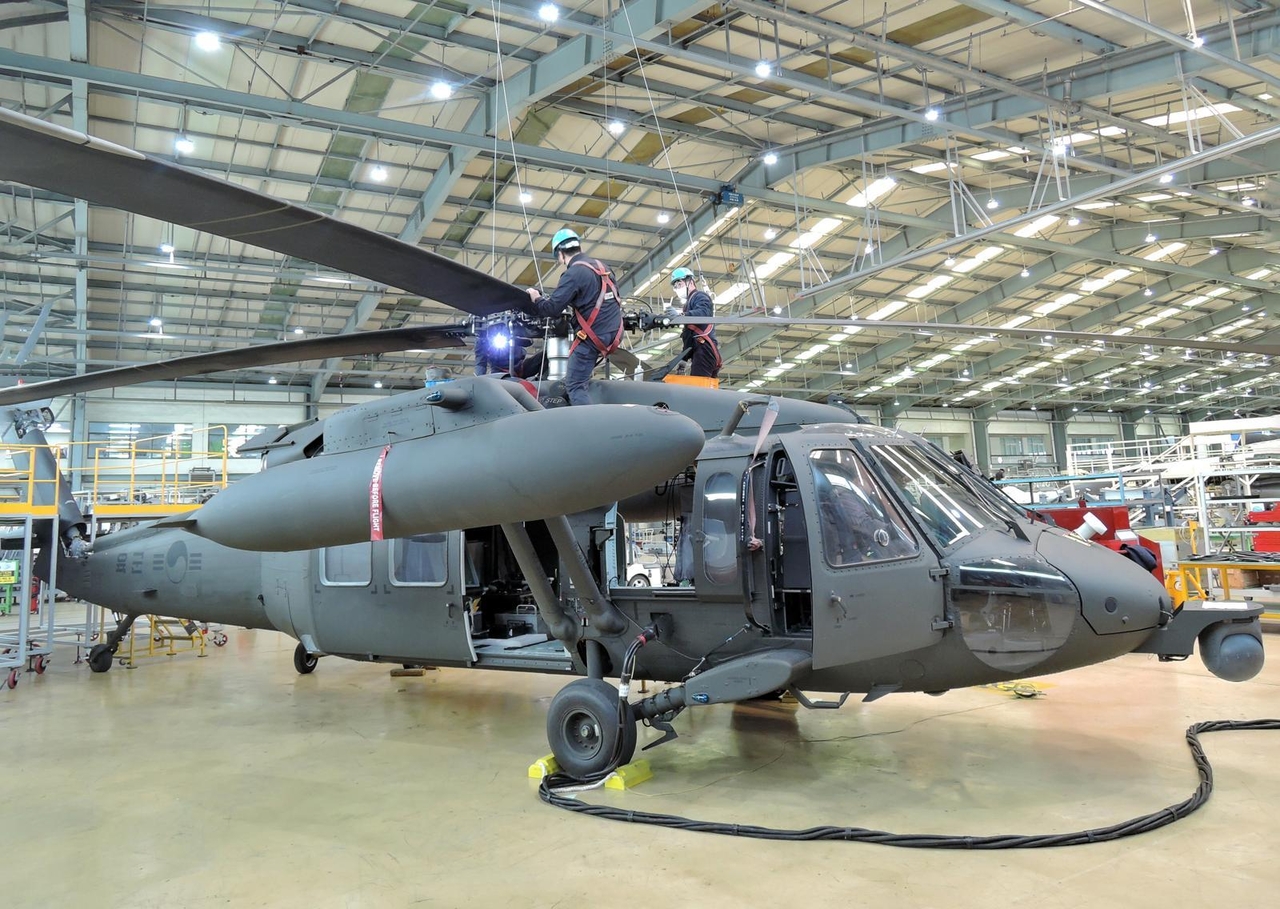 Technicians perform maintenance on a UH-60 helicopter at Korean Air's Busan Tech Center. (Korean Air)
