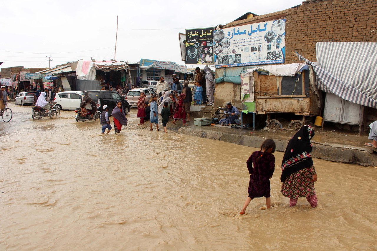 Residents wade through floodwaters after heavy rains in Kandahar, Afghanistan, Thursday. (EPA-Yonhap)