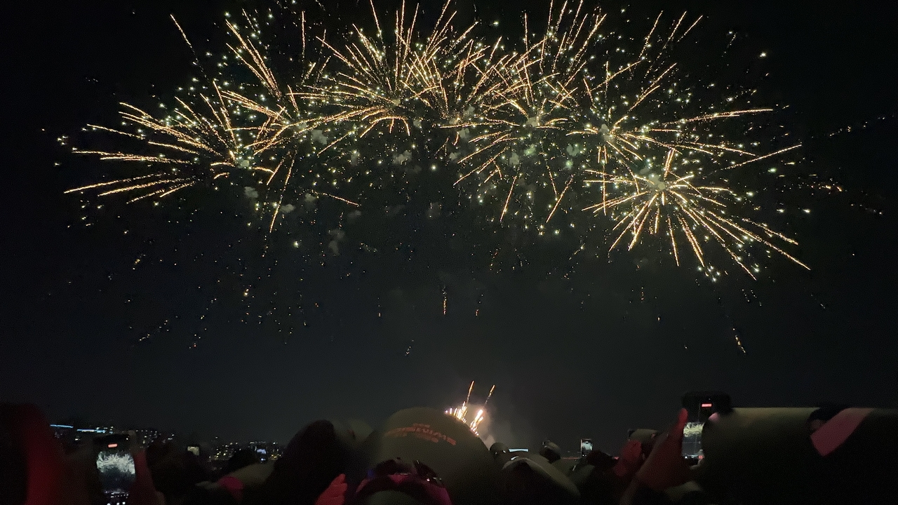 Fireworks timed to the tracks in BTS' newest album, "Arirang," is seen on the "Spotify X BTS Swimside" cruise in Yeouido, western Seoul, Saturday. (Lee Jung-joo/The Korea Herald)
