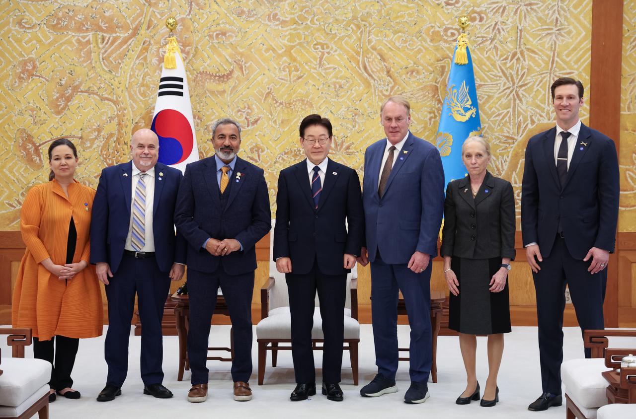 President Lee Jae Myung (center) meets with members of the Congressional Study Group on Korea  at Cheong Wa Dae in Seoul on Tuesday. From left are Reps. Jill Tokuda (D-Hawaii), Mark Pocan (D-Wisconsin), Ami Bera (D-California), Lee, Ryan Zinke (R-Montana), Mary Gay Scanlon (D-Pennsylvania) and Pat Harrigan (R-North Carolina). (Yonhap)