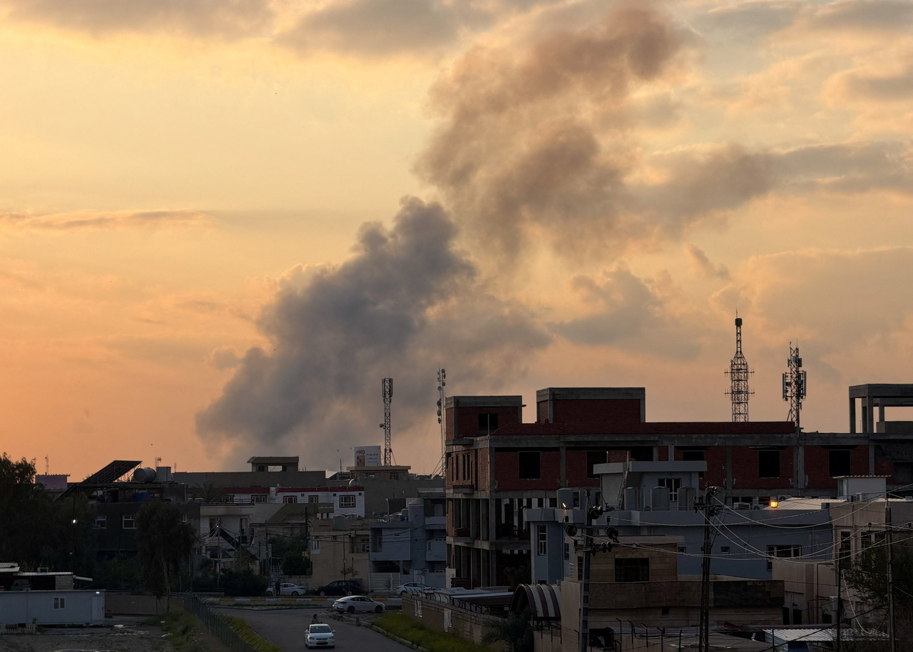 This file photo shows smoke rising following an air strike near Kirkuk International Airport in Kirkuk, Iraq, Saturday. (Reuters via Yonhap)