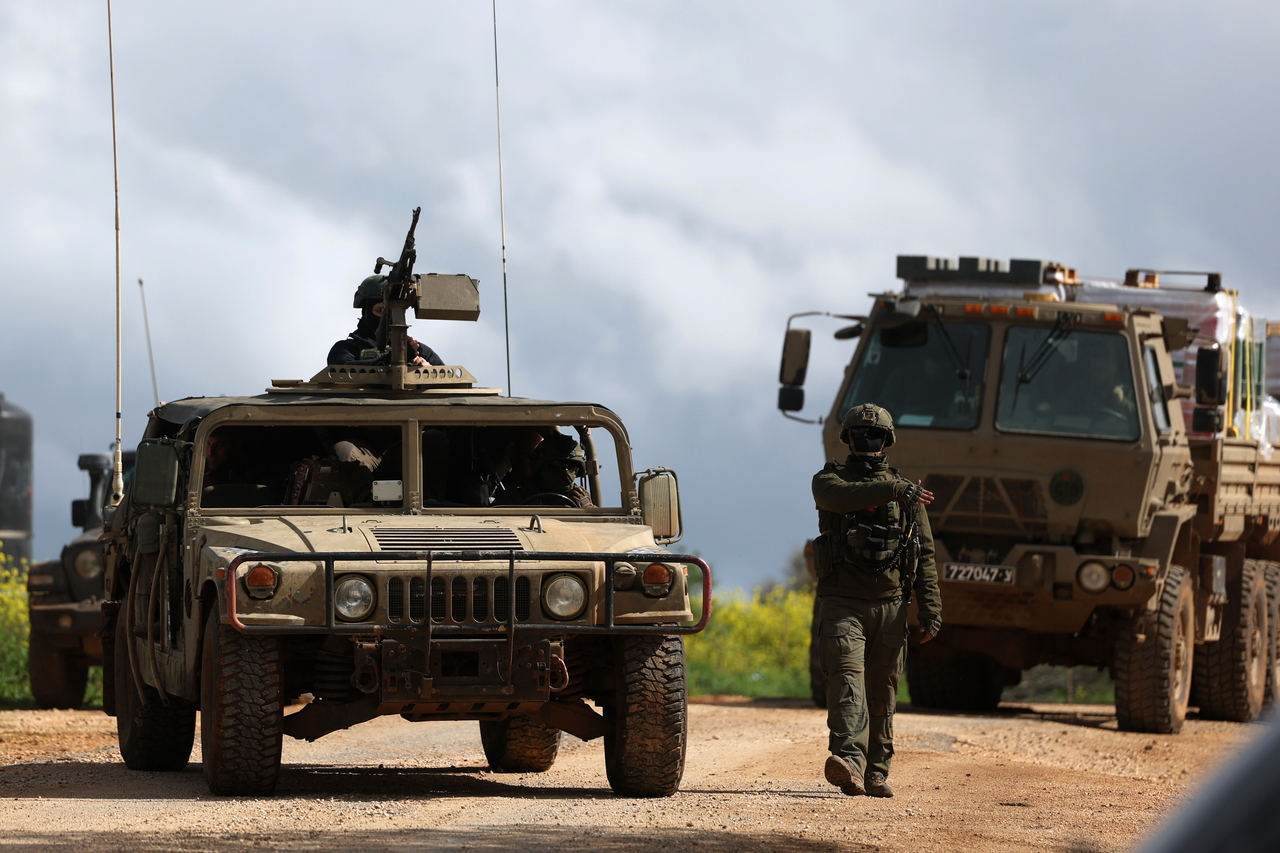 Israeli soldiers with their military vehicles gather at an undisclosed position near the Israel-Lebanon border, on March 30, 2026. .  (EPA-Yonhap)