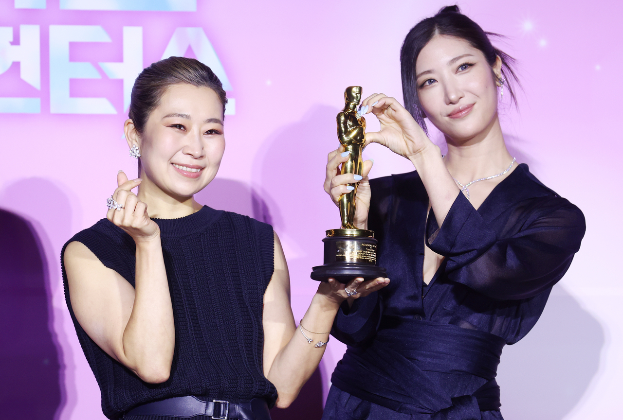 Director Maggie Kang (left) and singer-songwriter Ejae pose at a press conference for Netflix's "KPop Demon Hunters" at CGV Yongsan in Seoul on Wednesday. (Yonhap)