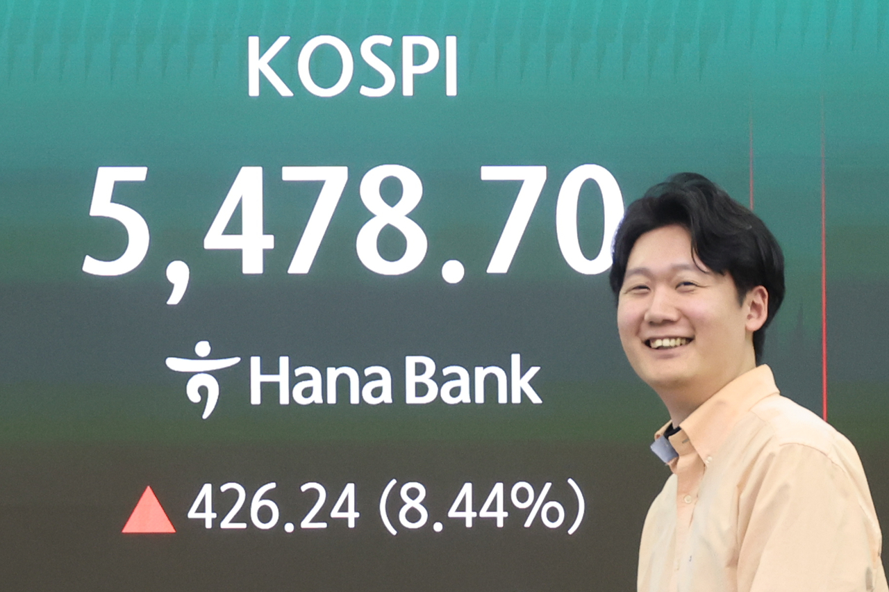 The benchmark Kospi’s closing level of 5,478.70 is displayed on a screen at a dealing room of Hana Bank in central Seoul.
