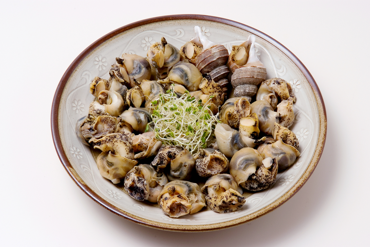 Boiled sea snails are often sliced and then dipped in gochujang with vinegar (Getty Image)