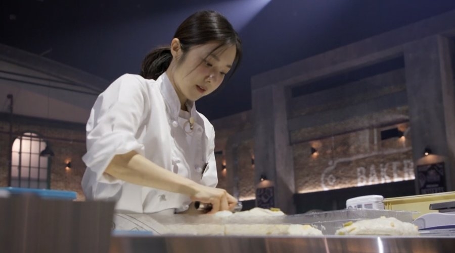 A contestant prepares bread on "Cheonha Bakery: Bake Your Dream." (MBN)