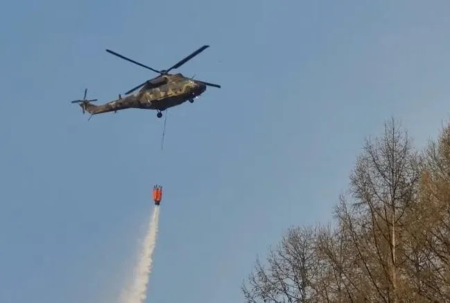 A South Korean Army Surion helicopter sprays water over a wildfire in Yanggu, Gangwon Province, 2024. (Republic of Korea Army)