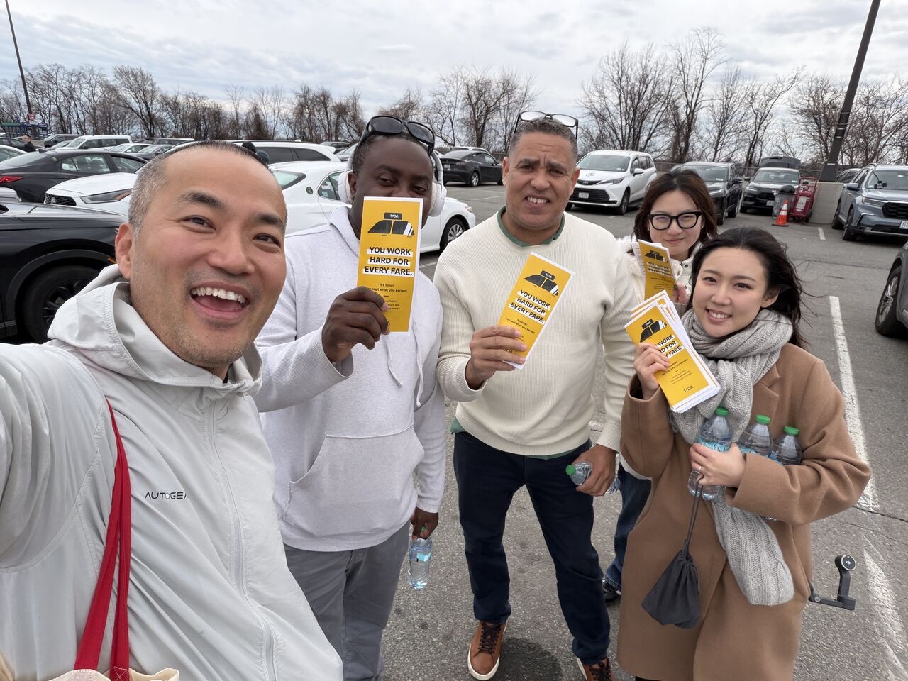 Tada CEO Kay Woo (left) takes a photo with drivers at LaGuardia Airport in New York. (Tada)